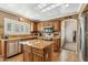 Traditional kitchen with wood cabinetry and stainless steel appliances at 2249 E Taxidea Way, Phoenix, AZ 85048