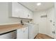 Functional laundry room equipped with a washer, dryer, storage cabinets, and a folding counter at 2249 E Taxidea Way, Phoenix, AZ 85048