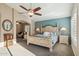 Relaxing primary bedroom featuring stylish accent wall and sitting area with natural lighting at 2249 E Taxidea Way, Phoenix, AZ 85048