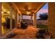 Relaxing covered patio with terracotta tile, comfortable seating and view to backyard at 2249 E Taxidea Way, Phoenix, AZ 85048