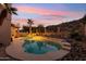 A refreshing pool with desert landscaping and a view of the mountains at 2249 E Taxidea Way, Phoenix, AZ 85048