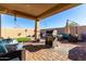 Covered patio with grill, seating area, and artificial turf at 26407 N 166Th Ave, Surprise, AZ 85387