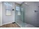 Bathroom with walk-in shower, gray tile, and modern fixtures at 26407 N 166Th Ave, Surprise, AZ 85387