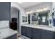 Double vanity bathroom with granite countertop and gray cabinets at 26407 N 166Th Ave, Surprise, AZ 85387