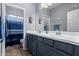 Double vanity bathroom with blue and white color scheme at 26407 N 166Th Ave, Surprise, AZ 85387