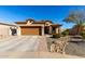 Single-story house with brown garage door and landscaped yard at 26407 N 166Th Ave Ave, Surprise, AZ 85387