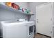 Laundry room with washer, dryer, and storage shelves at 26407 N 166Th Ave, Surprise, AZ 85387