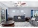 Living room with gray couches, wood floor and ceiling fan at 26407 N 166Th Ave, Surprise, AZ 85387