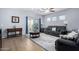 Living room with gray couches, wood floor and ceiling fan at 26407 N 166Th Ave, Surprise, AZ 85387