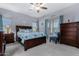 Main bedroom with a king-size bed, dresser, and ceiling fan at 26407 N 166Th Ave, Surprise, AZ 85387