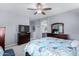 Main bedroom with a king-size bed, dresser, and ceiling fan at 26407 N 166Th Ave, Surprise, AZ 85387