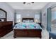 Main bedroom with a king-size bed, dresser, and ceiling fan at 26407 N 166Th Ave, Surprise, AZ 85387