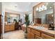 Spa-like bathroom with soaking tub, double vanity, and wood cabinets at 29305 N 146Th St, Scottsdale, AZ 85262