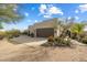 Spanish style home with landscaped desert front yard, large garage, and gated entry at 29305 N 146Th St, Scottsdale, AZ 85262