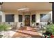 Covered porch with ornate door and comfortable seating area with rug at 29305 N 146Th St, Scottsdale, AZ 85262