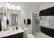 Modern bathroom with glass-enclosed shower, dark vanity, and a neutral color palette provides a serene and functional space at 3446 N Mayfair St, Mesa, AZ 85213