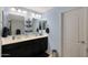 Bathroom features dual sinks with a shared countertop and a wall-mounted shelf at 3446 N Mayfair St, Mesa, AZ 85213