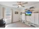 Bright bedroom with ceiling fan, hardwood floors, walk-in closet, and custom-built storage and shelving at 3446 N Mayfair St, Mesa, AZ 85213