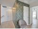 Light and airy hallway with chair and floral wallpaper, leading to the spacious living area at 3446 N Mayfair St, Mesa, AZ 85213