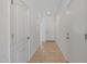 Bright hallway features neutral tile flooring and fresh white walls, connecting the various living spaces in the home at 3446 N Mayfair St, Mesa, AZ 85213