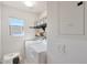 Bright laundry room with modern appliances, shelves, and natural light from a window at 3446 N Mayfair St, Mesa, AZ 85213