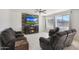 Comfortable living room with reclining sofa, a modern fireplace, and a ceiling fan at 3446 N Mayfair St, Mesa, AZ 85213