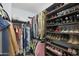 Spacious walk-in closet offers plenty of space for clothes and shoes on multiple shelves and racks at 3446 N Mayfair St, Mesa, AZ 85213
