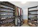 Large walk-in closet has ample storage for clothes, shoes, and accessories on many wooden shelves at 3446 N Mayfair St, Mesa, AZ 85213