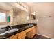 Bathroom with granite countertops, double sinks, and a soaking tub at 35834 W Cartegna Ln, Maricopa, AZ 85138