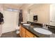 Clean bathroom with double vanity and shower/tub combo at 35834 W Cartegna Ln, Maricopa, AZ 85138