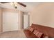 Bedroom with a futon and double doors leading to a closet at 35834 W Cartegna Ln, Maricopa, AZ 85138