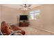 Bedroom with a futon and a large TV at 35834 W Cartegna Ln, Maricopa, AZ 85138