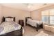 Bedroom with two twin beds and a nightstand at 35834 W Cartegna Ln, Maricopa, AZ 85138