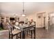 Bright dining area with modern table and chairs, open to the living area at 35834 W Cartegna Ln, Maricopa, AZ 85138