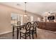 Dining area with table and chairs near kitchen and living room at 35834 W Cartegna Ln, Maricopa, AZ 85138