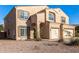 Two-story house with beige exterior, two-car garage, and small front yard at 35834 W Cartegna Ln, Maricopa, AZ 85138
