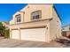 Two-story house with beige exterior, two-car garage, and small front yard at 35834 W Cartegna Ln, Maricopa, AZ 85138