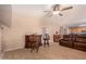 Gathering room with leather seating, wet bar, and a view into the kitchen at 35834 W Cartegna Ln, Maricopa, AZ 85138