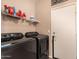 Laundry room with washer, dryer, and shelving at 35834 W Cartegna Ln, Maricopa, AZ 85138