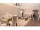Living room with tiled floors, sofa, coffee table, and dining area at 35834 W Cartegna Ln, Maricopa, AZ 85138