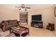 Spacious living room with a fireplace and tile flooring at 35834 W Cartegna Ln, Maricopa, AZ 85138