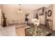 Living room with tiled floors, couch, coffee table, and view of staircase at 35834 W Cartegna Ln, Maricopa, AZ 85138