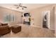 Relaxing living room with tile floors, large window, and powder room at 35834 W Cartegna Ln, Maricopa, AZ 85138