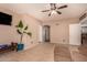 Cozy living room features tile flooring and a ceiling fan at 35834 W Cartegna Ln, Maricopa, AZ 85138