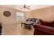 Living room featuring a comfortable couch and tile floor at 35834 W Cartegna Ln, Maricopa, AZ 85138