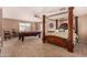 Main bedroom with a four-poster bed and pool table at 35834 W Cartegna Ln, Maricopa, AZ 85138