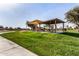 Community playground with shaded seating and play structures at 35834 W Cartegna Ln, Maricopa, AZ 85138