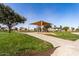 Community playground with shade structure at 35834 W Cartegna Ln, Maricopa, AZ 85138