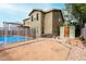 View of backyard with pool, rock landscaping, and storage shed at 415 W Midland Ln, Gilbert, AZ 85233