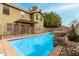 Backyard pool with secure fencing, mature trees and lush landscape providing ultimate privacy at 415 W Midland Ln, Gilbert, AZ 85233